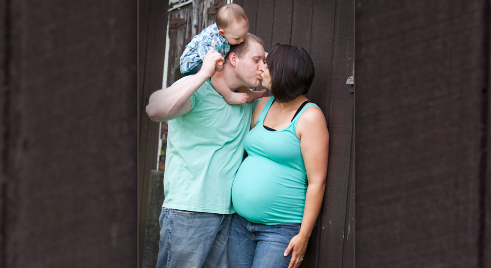 Outdoor picture of growing family of a son on his father