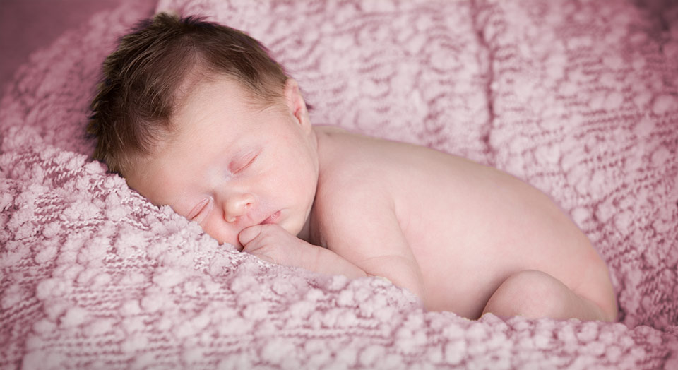 Depth of field photography of newborn baby on special soft texture cotton blanket
